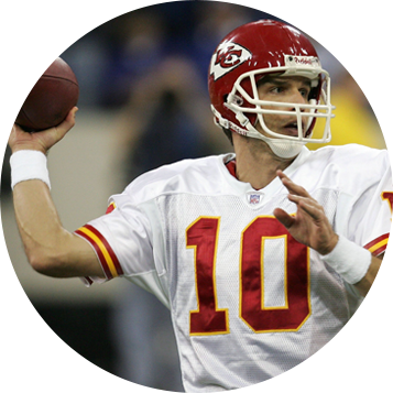 A man in white and red uniform throwing a football.